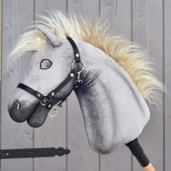 LarDen Hobby Horse Silver Dream with grey plush head, cream mane and black halter, side view by a wooden stable door