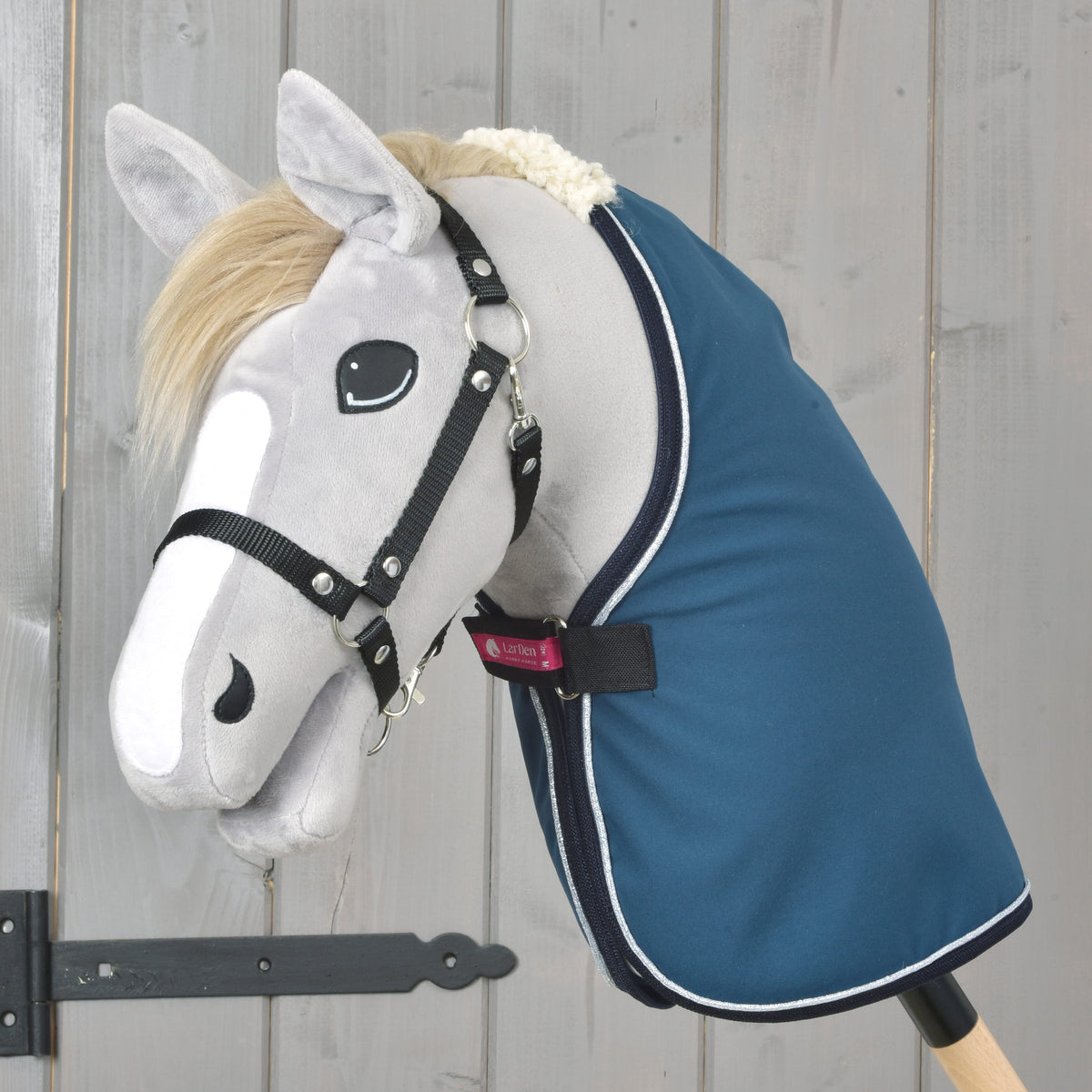 Blue stable blanket worn by a grey Hobby Horse, with silver trim and cream neck lining