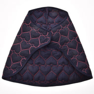 Blanket Pink Heart by Hobby Horse LarDen is a dark blue quilted cape with pink heart-shaped stitching, inspired by a warm horse blanket, and features a curved front opening, shown against a white background.