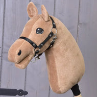 The Build your horse by related_to_12441055625556 features a caramel hobby horse head with a beige yarn mane, black bridle, smiling face, and black button eyes, set against a wooden backdrop.