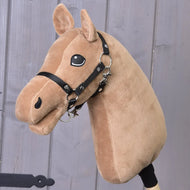 Build your horse by related_to_12441055625556 features a tan coat, black bridle, stitched details, and a chocolate yarn mane on a stick, showcased against a wooden background.