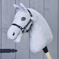 The Build your horse by related_to_12441055625556 is a handmade hobby horse with a plush gray head, black halter, and wooden stick, shown against gray wooden paneling.