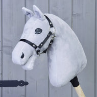 The "Build your horse" by related_to_12441055625556 is a light grey hobby horse with a brown-chestnut mane and black bridle, mounted on a wooden stick and pictured against a gray wooden wall.