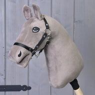 The Build your horse by related_to_12441055625556 features a taupe tricolor faux fur head, black bridle with reins, and wooden stick, shown against a gray wooden wall.