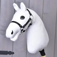 The Build your horse hobby horse by related_to_12441055625556 features a white plush head, light grey mane, and black bridle on a wooden stick, displayed against a gray wooden background.