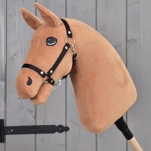 The "Build your horse" by related_to_12441055625556 is a handmade chestnut hobby horse head with a black harness on a stick, featuring sewn-on eyes and nostrils, set against a gray wooden background.