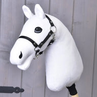 The Build your horse by related_to_12441055625556 features a white hobby horse with light grey yarn mane, cartoon-style eye, black reins on a wooden stick, shown against a light gray wooden background.